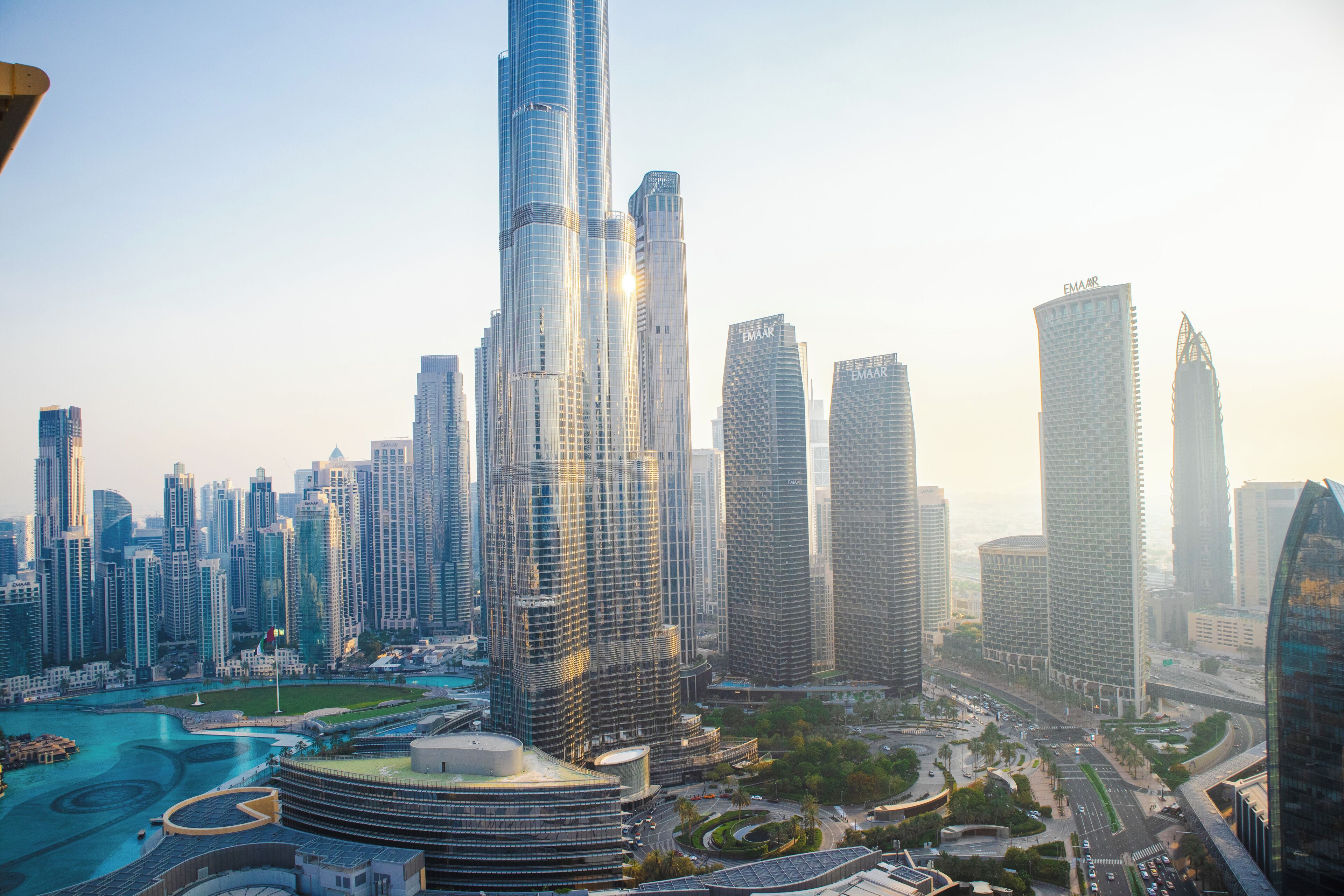 A high-rise urban skyline with modern architecture, including a prominent curved skyscraper and several other tall buildings.