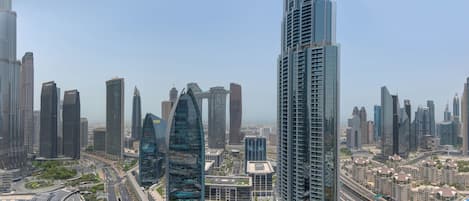 A high-rise building with a modern glass facade and a prominent "EMAAR" sign.