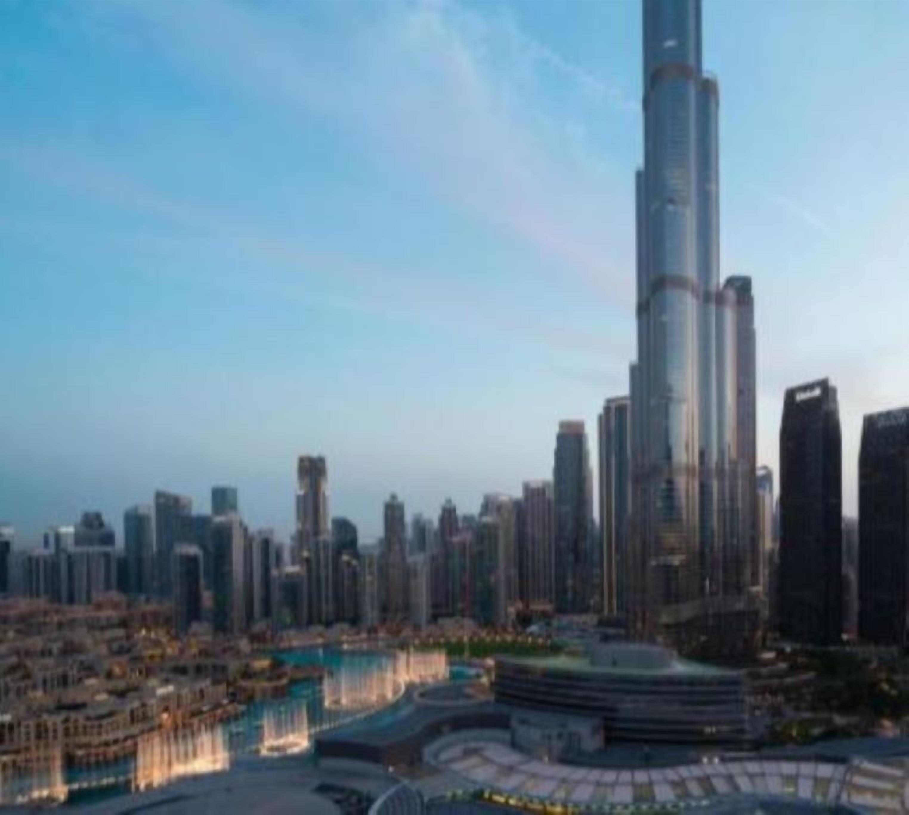 A high-rise building with a unique cylindrical shape, surrounded by other skyscrapers.