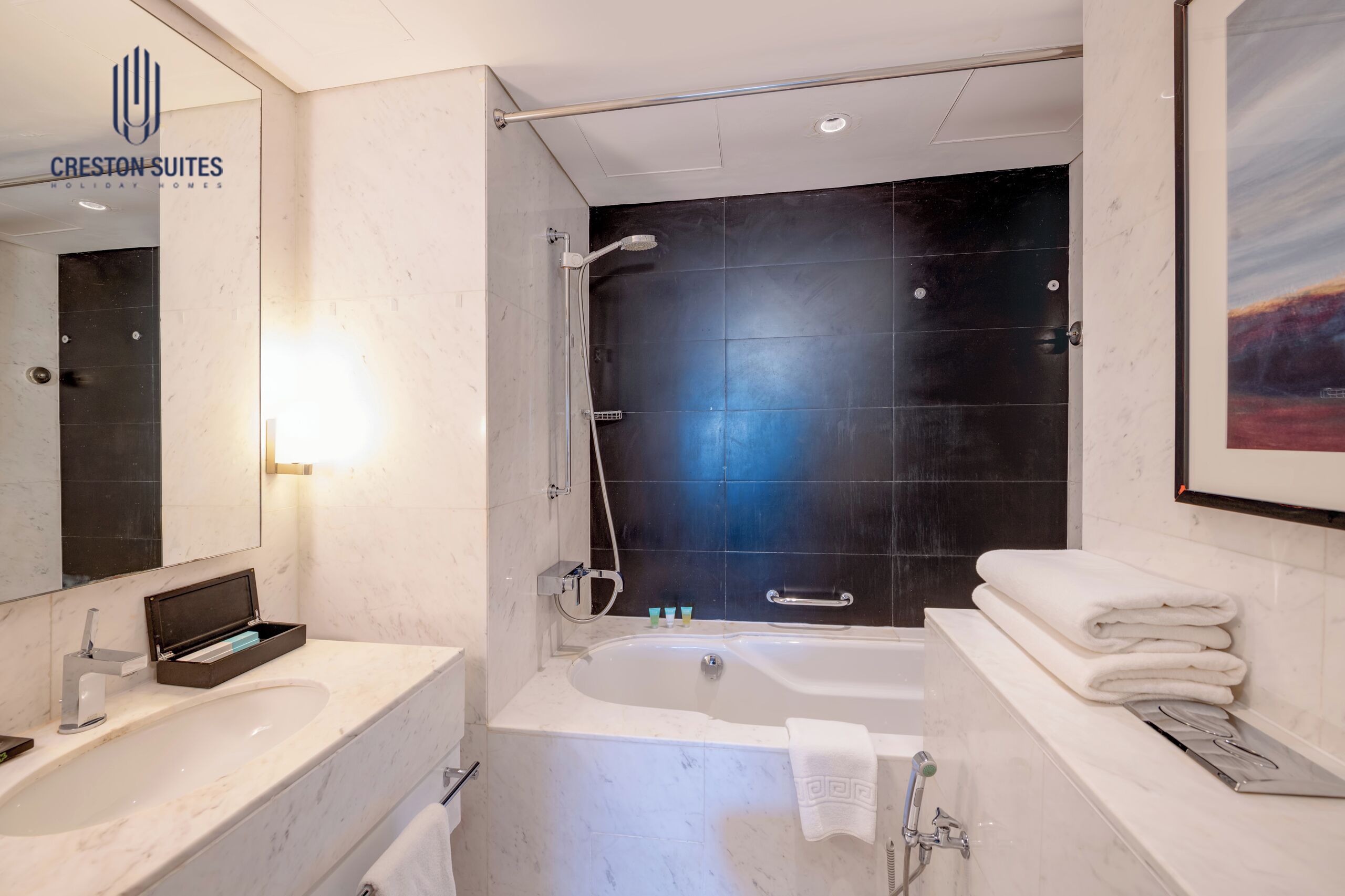 A modern bathroom with a bathtub, a shower, a sink, and a vanity.