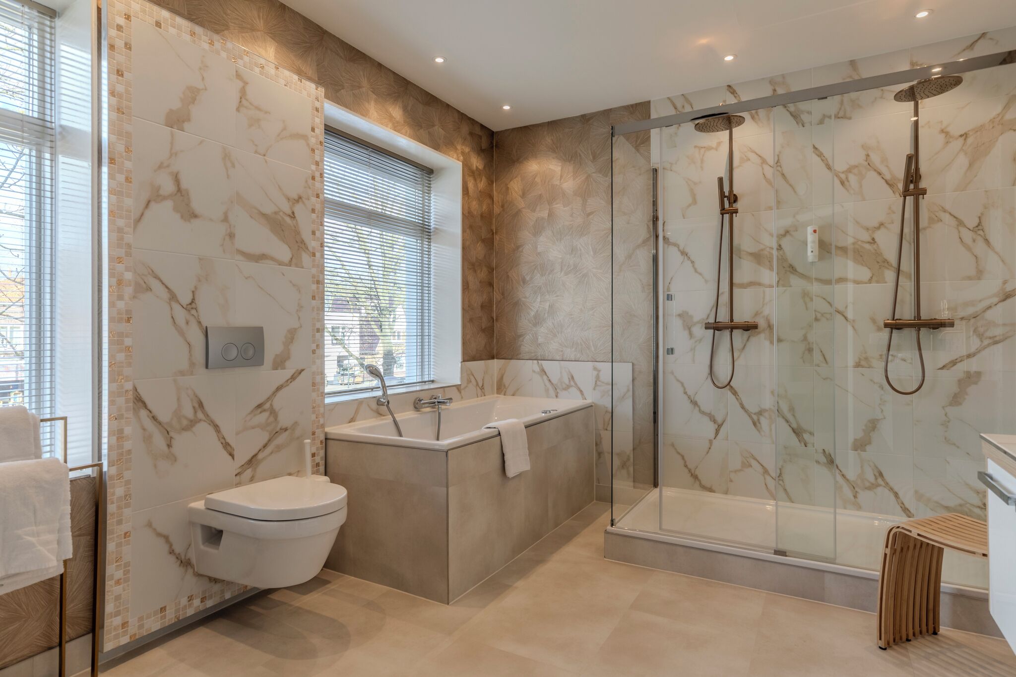A modern bathroom with a freestanding bathtub, a glass-enclosed shower, and a toilet.