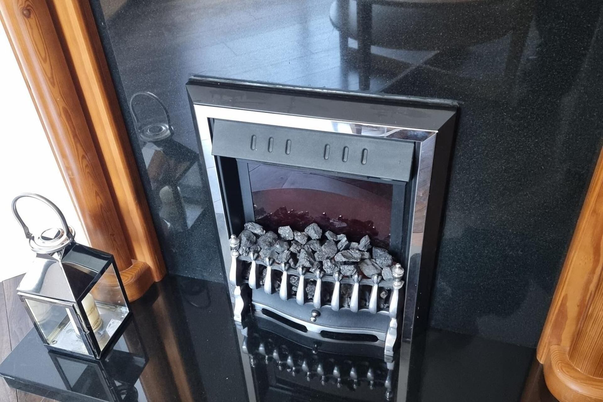 A black metal device with a grid of small openings, possibly a ventilation or filtration system, on a dark countertop.