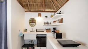 A compact kitchen with a built-in dishwasher, a toaster, and a small refrigerator. - Charming rooftop bungalow 1 block from the beach! (Corral del Risco)