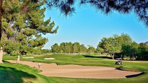 A golf course with sand bunkers, a putting green, and a clear blue sky. - CASA FAMILIA - 1st floor 2-bedroom unit (Phoenix)