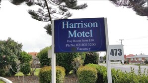 A motel sign with the name 'Harrison Motel' and a phone number. - harrison motel (Auckland)