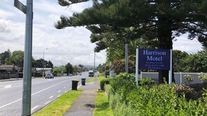 A motel sign with the name 'Harrison Motel' and a phone number. - harrison motel (Auckland)