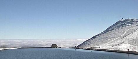 A large body of water with a snow-covered mountain in the background.