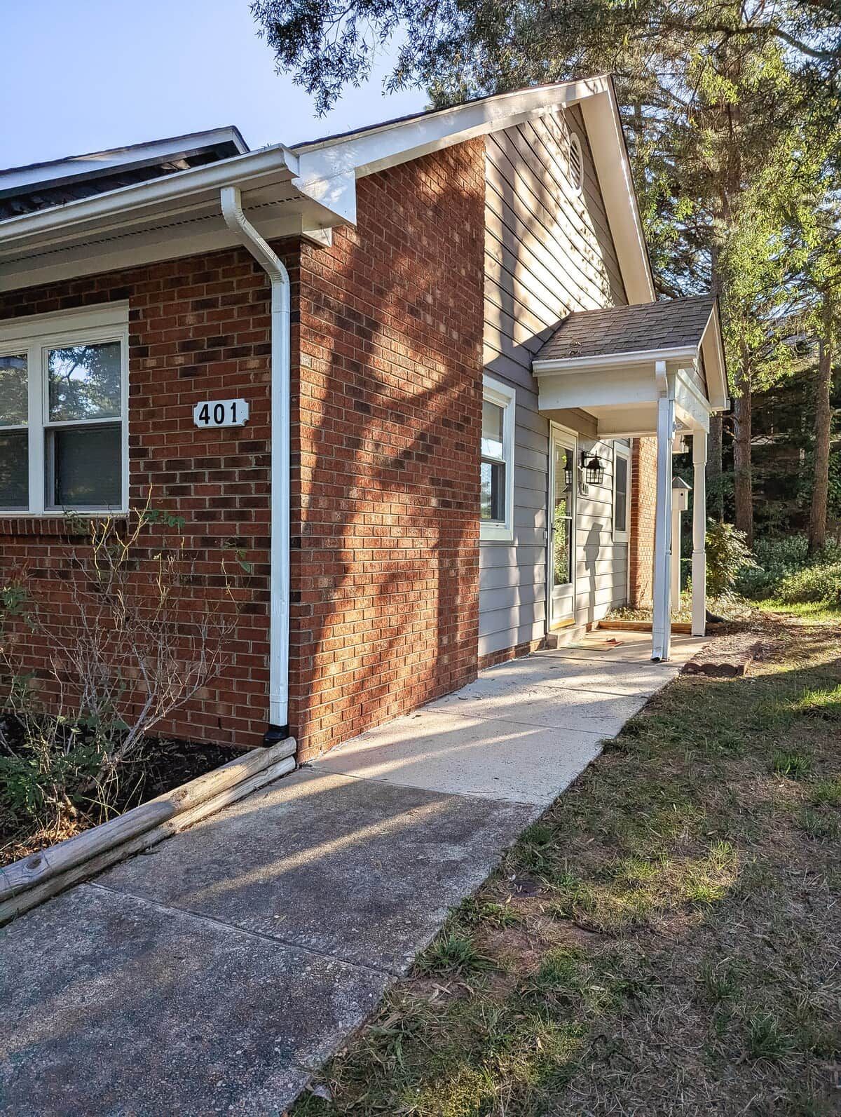 A two-story building with a brick facade, a visible number '401', and a covered porch area.