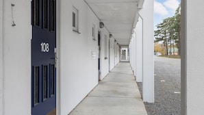 Passadís amb portes numerades 108, que donen accés a habitacions individuals.