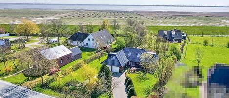 A residential area with houses, a road, and fields.