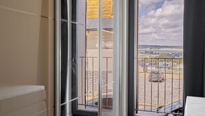 A room with a view of a parking lot and buildings through a large window. - Plešivec by Interhome (Abertamy)