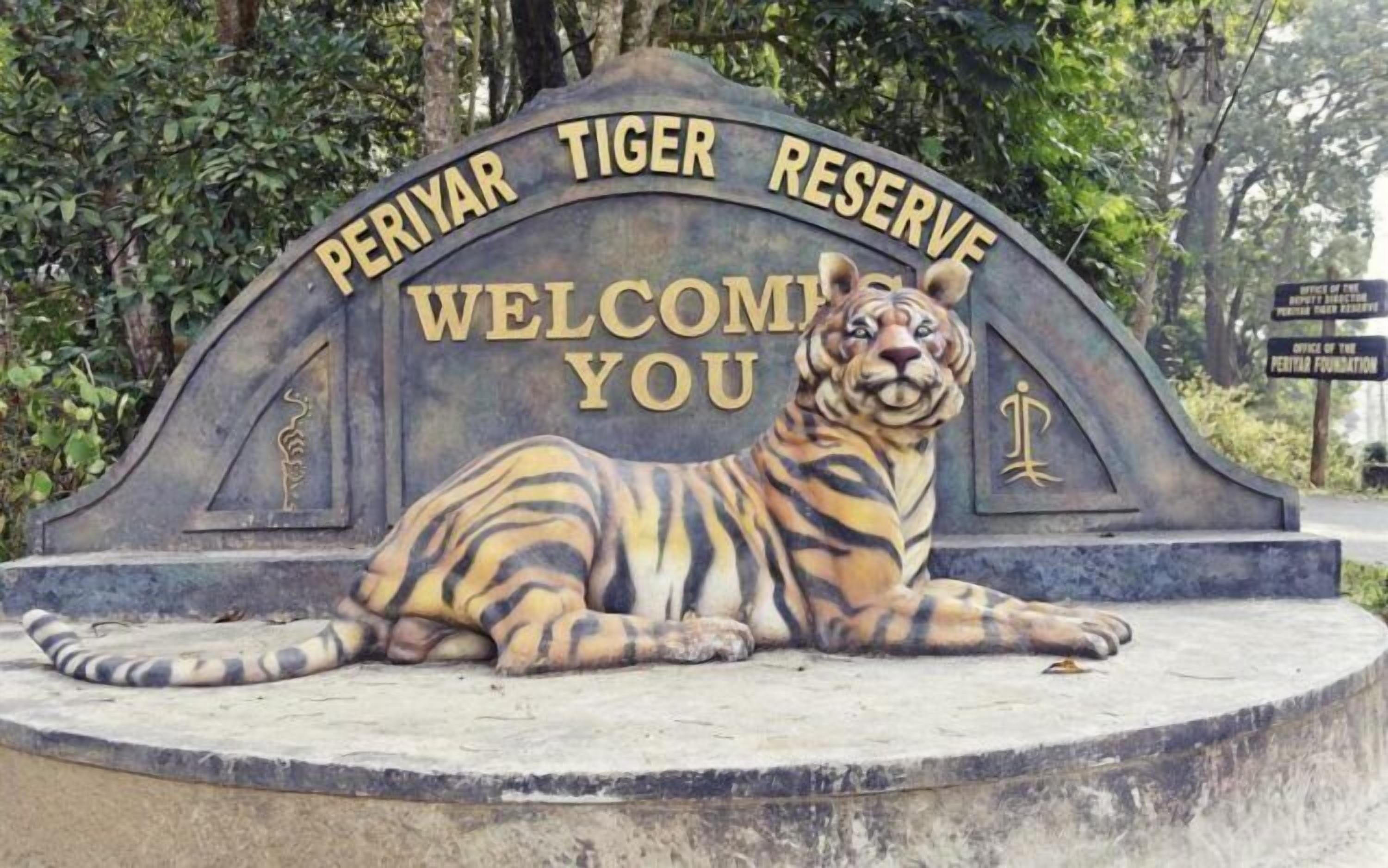 A sign for Periyar Tiger Reserve with a tiger illustration and the words "WELCOME YOU".