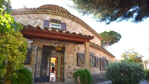 A stone building with a tiled roof, a wooden door, and a sign that reads "Polo Club". - Villa Petit Castell 10 people Costa Brava (PALAFOLLS)