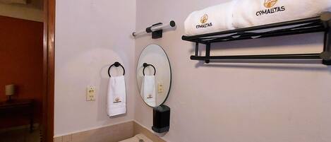 A bathroom with a sink, towel rack, and a mirror.