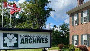 A sign for Norfolk County Archives with a brick building in the background. - Courtland Heaven Retreats (Courtland)