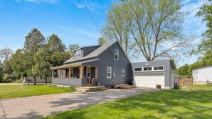 A two-story house with a front porch, a garage, and a well-maintained lawn. - Courtland Heaven Retreats (Courtland)