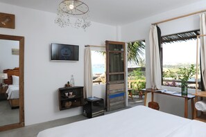 A hotel room with a bed, bedside table, mirror, artwork, and a view of the outdoors. - Stop And Go Lang Chai Bau Trang (Bac Binh)