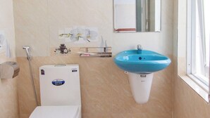 A bathroom with a toilet, a sink, a shower, and a window. - Thu Hien Hotel Pleiku - by BAY LUXURY (Gao)