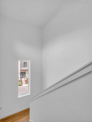 A room with a white wall and a window. - Luxury Townhouse w/Rooftop (Knoxville)