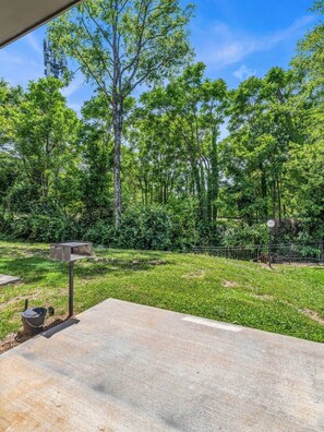 An outdoor area with a concrete patio, a metal mailbox, and a fence. - Luxury Townhouse w/Rooftop (Knoxville)