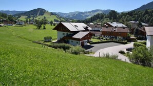 A residential area with houses, a playground, and a clear view of the surrounding hills.