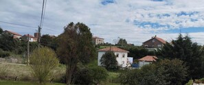 A residential area with houses, trees, and a clear sky. - C26A01 Apto Moderno en Tagle (Tagle)