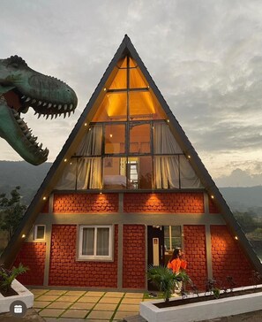 A triangular building with a brick facade and large windows. - Dinosaur Resort Lonavala (Mawal)