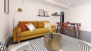 A modern living room with a mustard-colored sofa, a coffee table with a vase, and a dining area with red chairs and a dark table.
