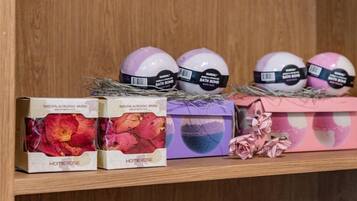 A shelf with bath bombs and rose petals.