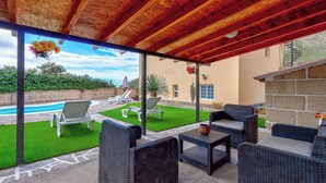 An outdoor patio with wicker furniture, a pool, and a view of the ocean. - Beautiful Arianny House With Pool (Arona)