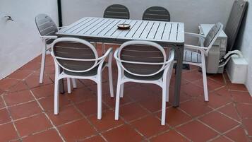 Enjoy a meal on the outdoor terrace with a view of the town and hill.