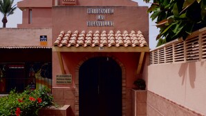 A residential building entrance with a sign reading 'RESIDENTIAL LAS BUGANVILLAS' and a private property notice. - Lovely Studio at 150 Meters From the Beach (Roquetas de Mar)