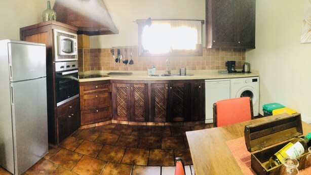 A compact kitchen with a refrigerator, oven, microwave, sink, and washing machine. - Casita Bellavista With Great Views in Mozaga (Teguise)