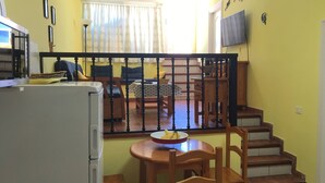 A compact living space with a dining area, a kitchen, and a staircase. - 2 Bd Apartment With Stunning View (Santiago del Teide)
