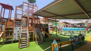 A children's play area with a wooden climbing structure, slides, and a covered seating area. - Modern Family Home Near the Pool With Private Jacuzzi! (Mogan)