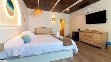 A modern bedroom with a large bed, a wooden ceiling, a TV, and a wooden cabinet.