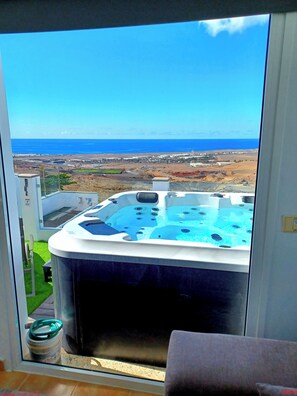 A hot tub with a view of the ocean and a distant cityscape. - Villa Vista Mar 2, sea Views, 600mbit Dsl, 280 Sqm, Whirlpool, Gaming Room mm (San Bartolome)
