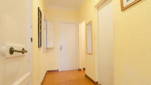 A narrow hallway with a wooden floor, white walls, and a door at the end. - Room in Guest Room - Private Room With 200m2 Sunny Terrace 6 (Barcelona)