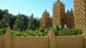 A traditional mud-brick building with multiple towers and a surrounding wall. - Playamar, Torremolinos, Beautiful Apartment by the Sea (Torremolinos)
