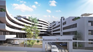 Un edificio residencial moderno con varios pisos y fachada curva.