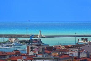 A coastal town with a lighthouse, marina, and buildings with red roofs. - Ardenza s Aires 600 Mt From Sea (Livorno)