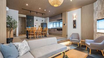 Deluxe Villa | Living area | 65-inch flat-screen TV with digital channels