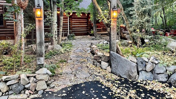 A rustic wooden archway leading to a cabin with a stone pathway. - Sundance Carriage House, Romantic, Sleeps 5 (Sundance)