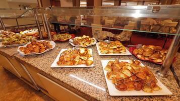 A buffet counter with various food items.