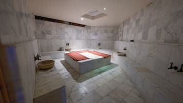 Un baño con una bañera grande, un lavabo y una zona de ducha.