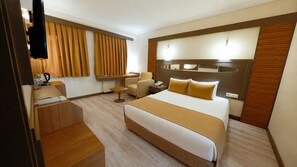 A hotel room with a large bed, a desk, a chair, and a television. - Lycus River Thermal Hotel (Denizli)
