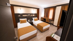 A hotel room with two beds, a desk, a television, and a mirror. - Lycus River Thermal Hotel (Denizli)