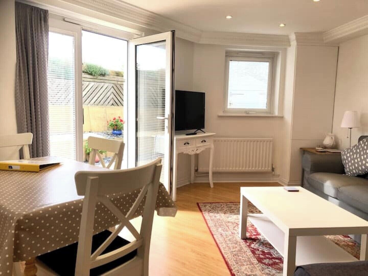 Pretty lounge room with patio doors leading to sunny south facing large terrace.