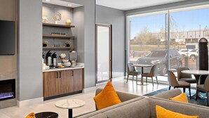 A modern hotel lobby with a coffee bar, seating area, and a fireplace. - La Quinta Inn & Suites by Wyndham La Habra (La Habra)
