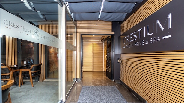 A hotel entrance with a modern design, featuring a reception desk, a staircase, and a sign for 'CRESTIUM'. - Crestium Taksim Prive&Spa (Istanbul)